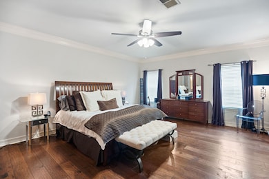 The wood floors continue in the large primary suite.