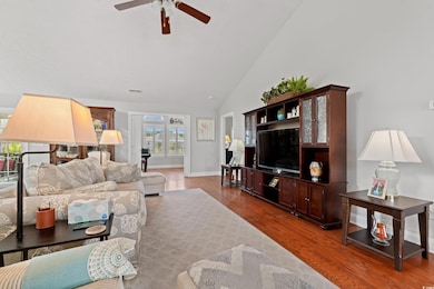 Living room featuring wood finished floors, high v