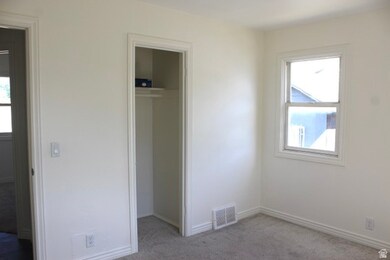 Bedroom featuring carpet floors and a walk in closet