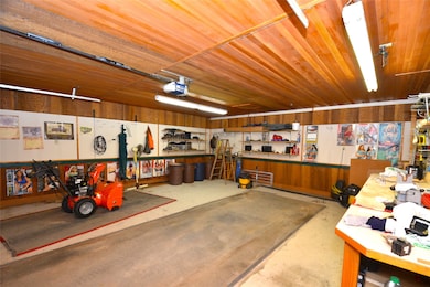 Garage with a workshop area and a garage door opener