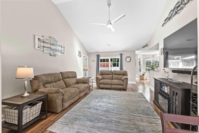 Living room with ceiling fan, dark hardwood / wood