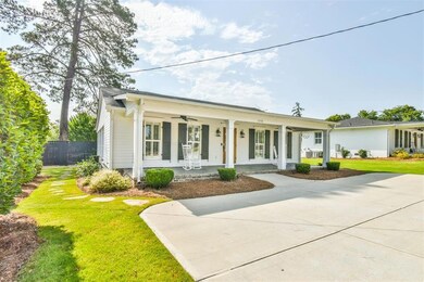 View of front of home featuring covered porch, a f