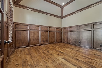 This rich study features elegant wood paneling and