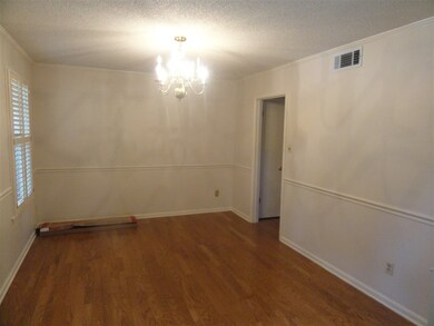 The dining room is off the entry and has new hardw