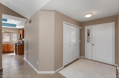 Foyer entrance with baseboards and light tile patterned floors