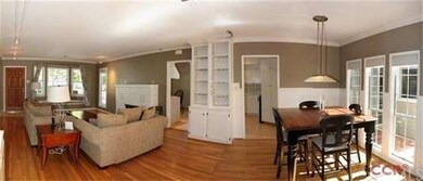 Living and formal dining room with wood floors, wi