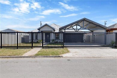 View of front of house featuring a metal fence