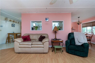 Living room has ceiling fan, two pass throughs to the Kitchen and an open floor plan which makes it easy to entertain.
