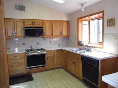Charming, spacious kitchen with decorative tile an