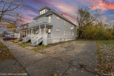 Traditional style home with a porch, a balcony, a chimney, and driveway