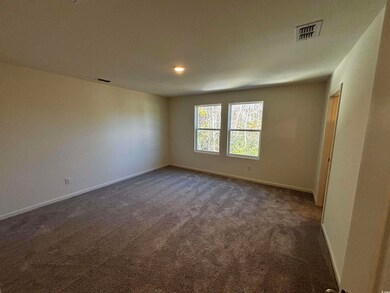 Empty room featuring dark carpet