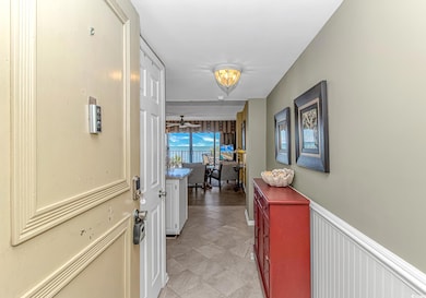 Hallway featuring light tile patterned floors