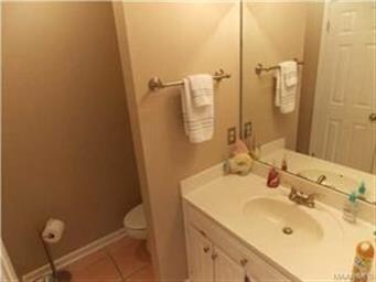 Hall half bath with large storage closet.
