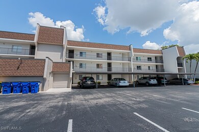 View of building exterior with covered parking