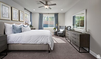 Carpeted bedroom with a ceiling fan and recessed lighting