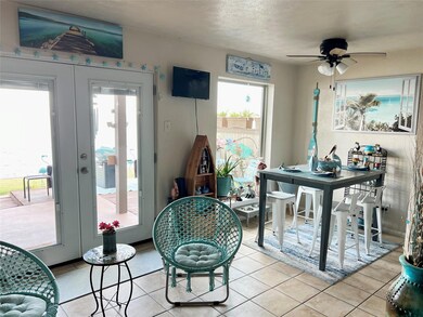 Tiled dining room with french doors and ceiling fan