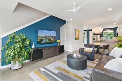 Living room featuring finished concrete floors, r