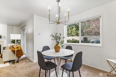 The dining area seamlessly connects the kitchen and living room, offering a perfect space for both casual meals and formal gatherings.