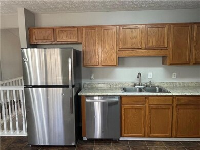 Kitchen featuring light countertops, a sink, stain