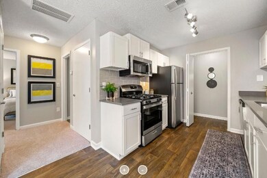Kitchen featuring stainless steel appliances, whit