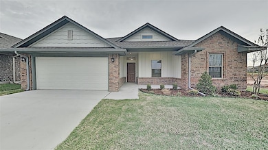 View of front of house with brick siding, driveway