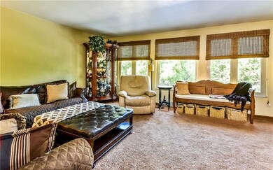 Living room boasts wall of windows with scenic vie
