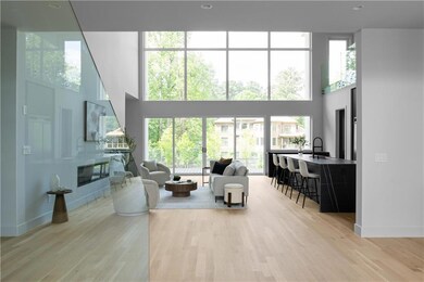 Living area featuring baseboards, light wood finis