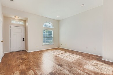 Foyer with wood finished floors and recessed lighting