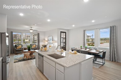 Kitchen featuring a healthy amount of sunlight, light hardwood / wood-style floors, ceiling fan, and sink