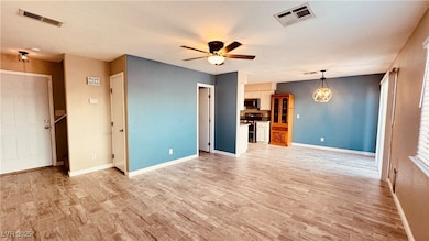 Unfurnished living room with light wood-style floo