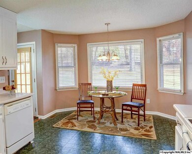 Enjoy a cup of coffee in the breakfast area right off the kitchen.  Natural light is plentiful through the large windows that look out into the large, fenced back yard.