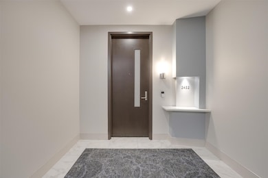 Entrance foyer with elevator and light marble finish floors