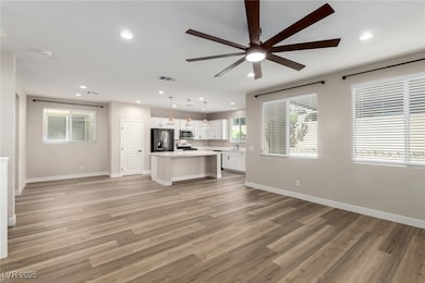 Unfurnished living room with ceiling fan, light wood-type flooring, and recessed lighting