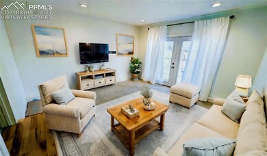 Living room with hardwood / wood-style flooring an