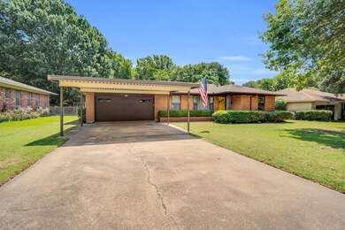 Single story home featuring a garage, a front lawn