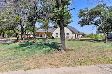 Front yard with view of small stable, home, and wo
