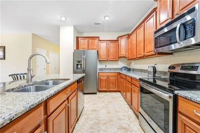 Large kitchen with stainless steel appliances and 