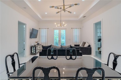 Dining room featuring visible vents, recessed lighting, marble finish floor, and an inviting chandelier