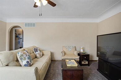Gorgeous cove ceiling and an arched entryway highlights the living room.