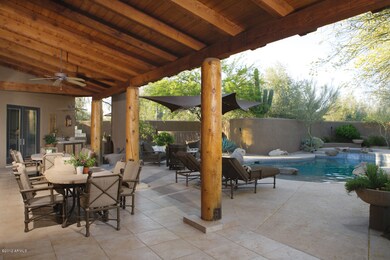 Deep covered patio surrounds pool/spa