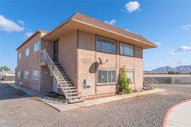 View of front of property with stairway, stucco si