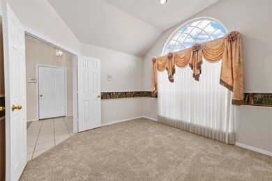 Carpeted spare room with vaulted ceiling