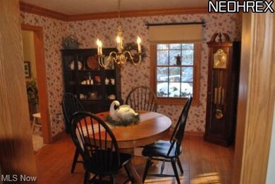 Formal Dining Room with Crown molding and hardwood