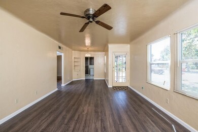 Spacious, bright living room with ceiling fan and 