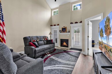 Living room with light wood-type flooring and high