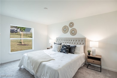 Bedroom with carpet flooring and baseboards