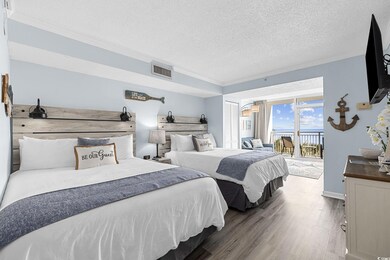 Bedroom featuring crown molding, access to exterior, wood finished floors, a textured ceiling, and baseboards