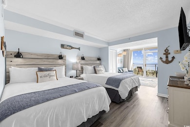 Bedroom featuring crown molding, access to exterio