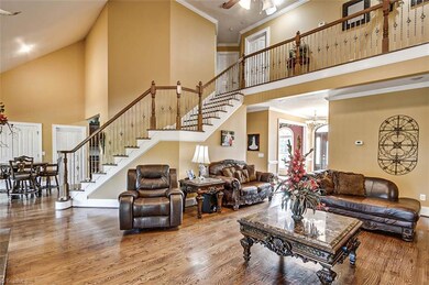 Great room with hardwood floors and 18' vaulted ceiling