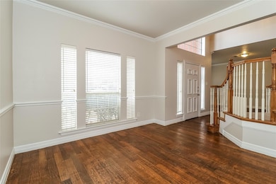 Entrance foyer featuring dark wood-type flooring a